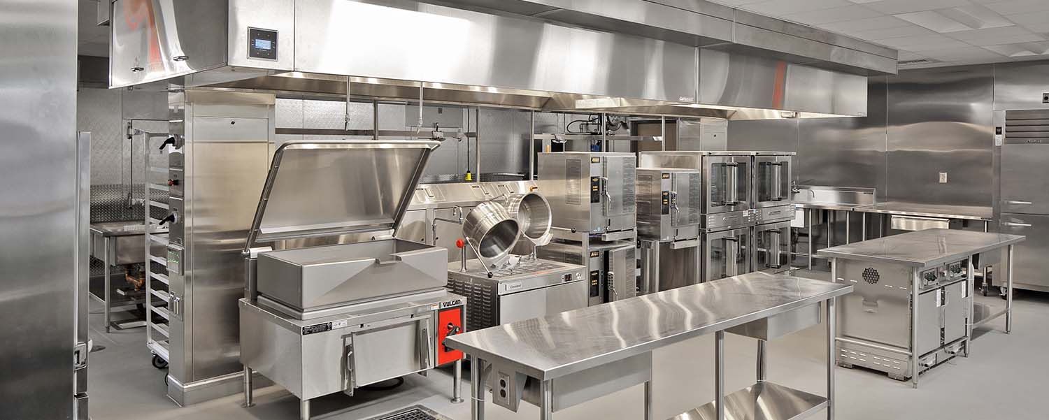 Stainless steel commercial kitchen with hood